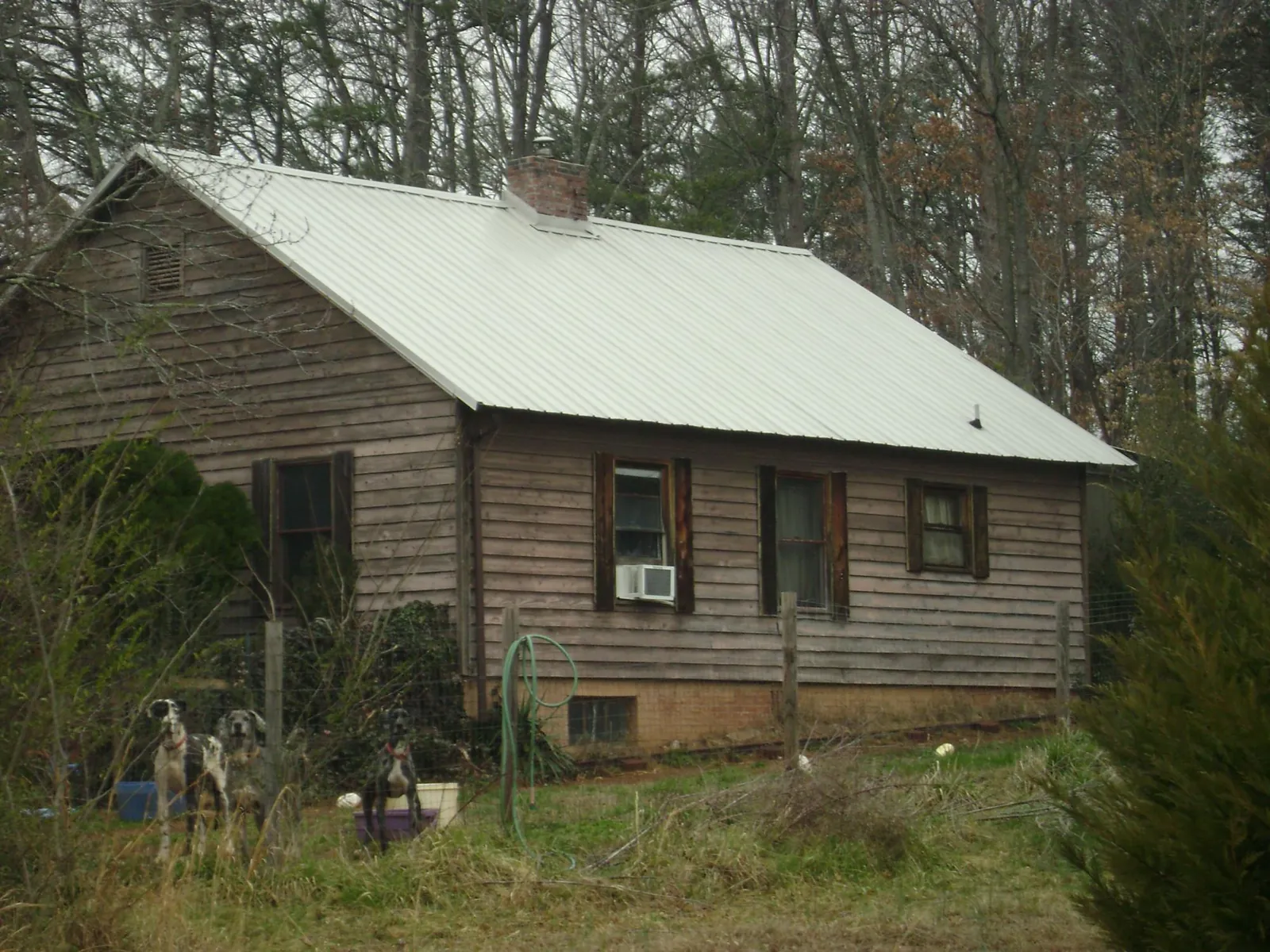 White metal roof on an old wood sided farmhouse, from a Metal Roof Installation job in North Lewisburg
